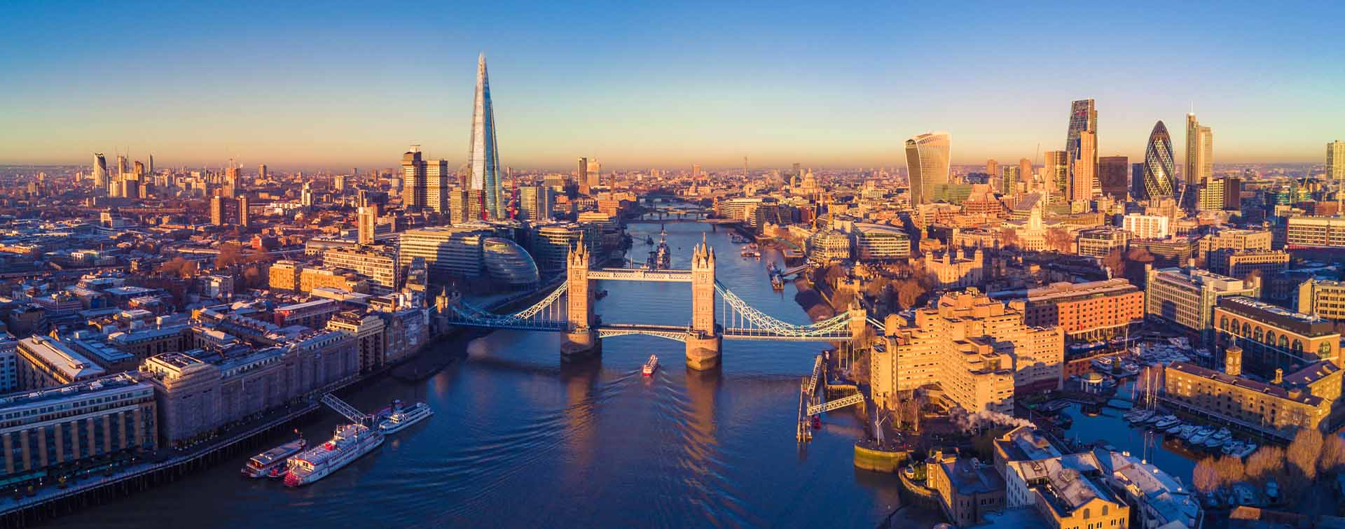 Skyline view of River Thames, Tower Bridge and Shard in London at sunrise