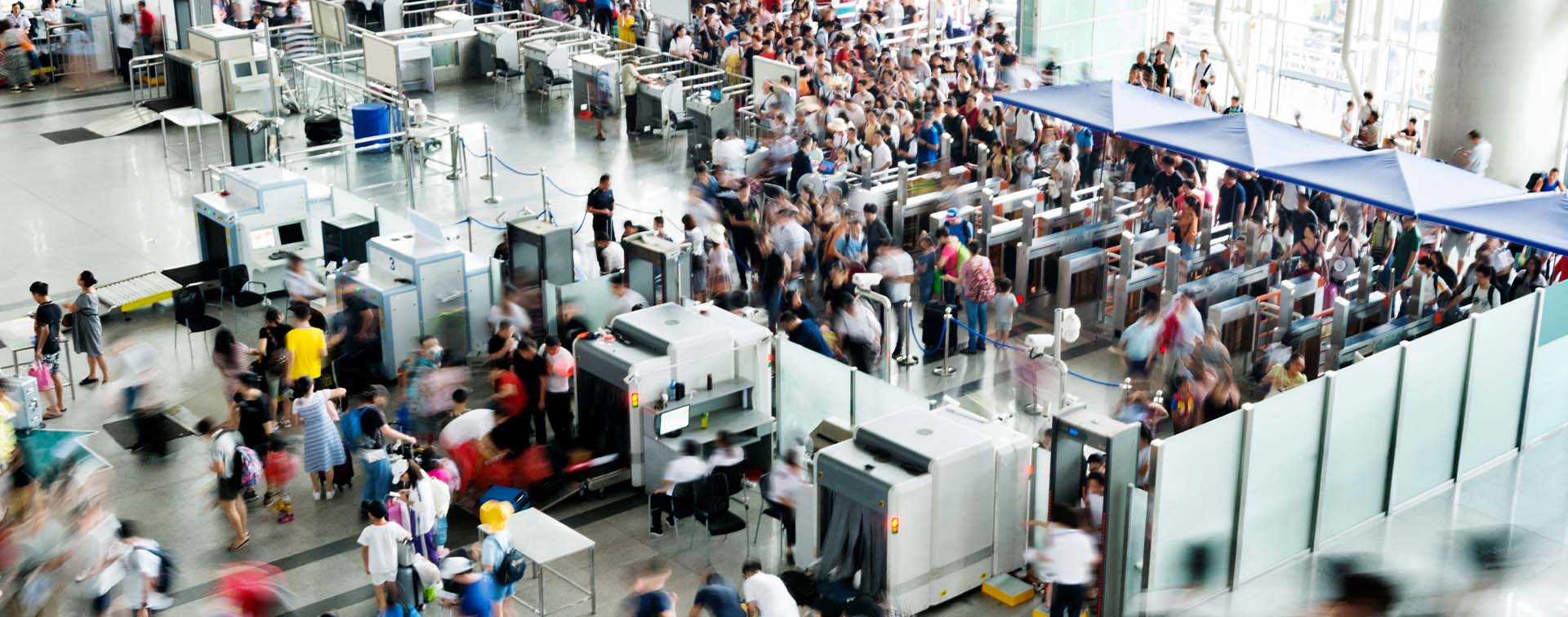 Crowd of people in railroad station lobby