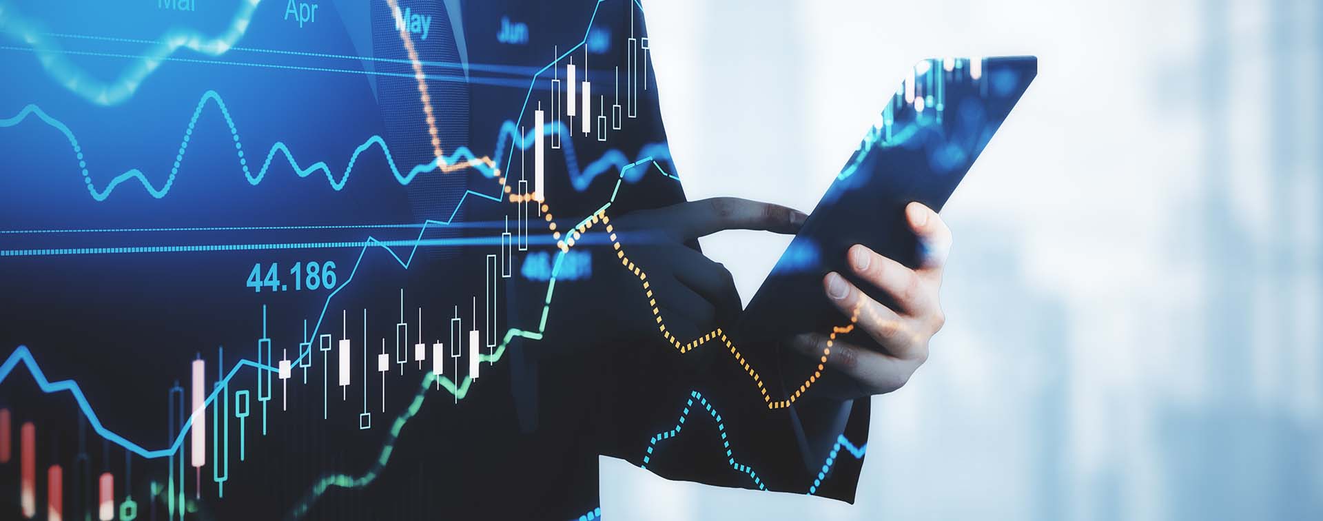 Fluctating charts superimposed over a person typing on a cellphone