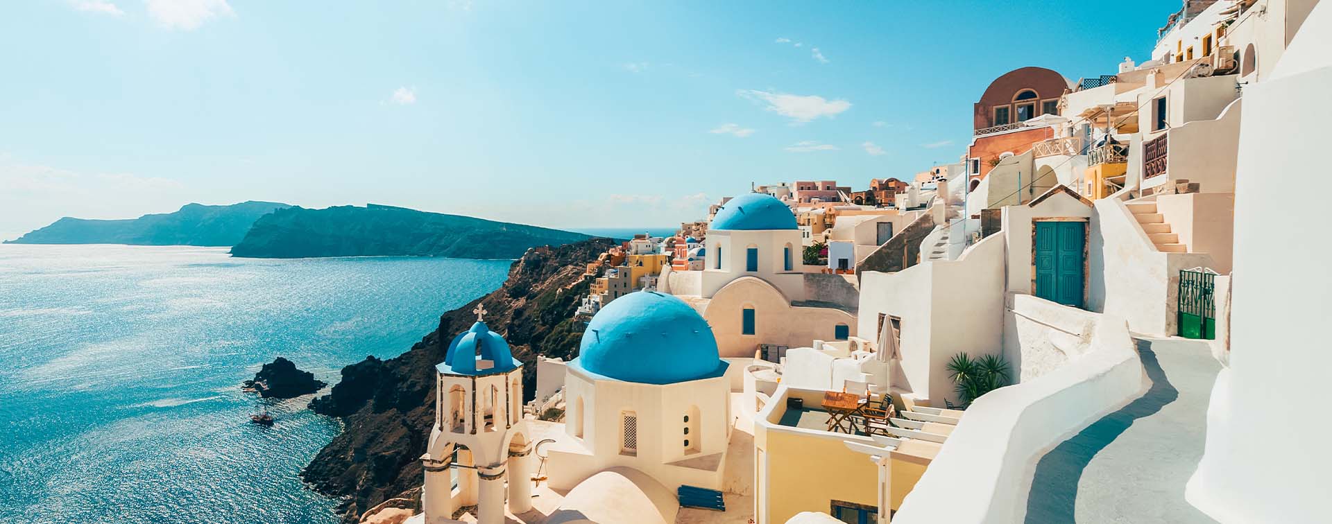 Scenic view of whitewashed buildings overlooking the ocean in Santorini, Greece