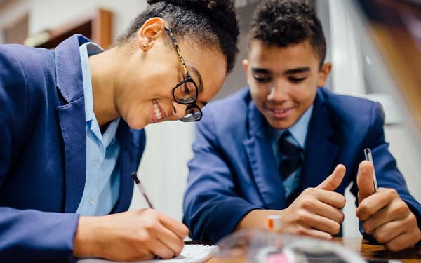 Smiling students doing homework
