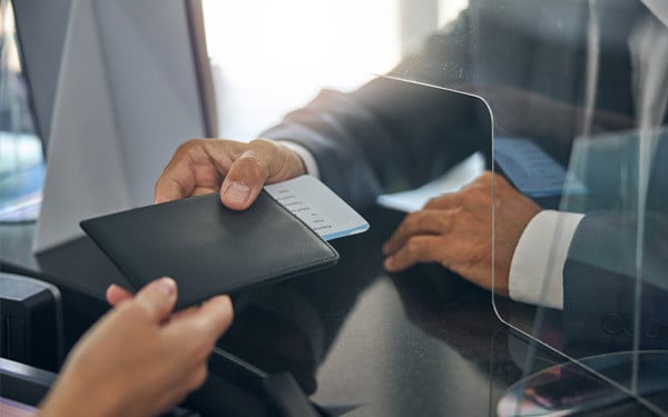 Male in suit checking in before flight