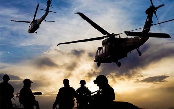 Silhouettes of soldiers during Military Mission at dusk