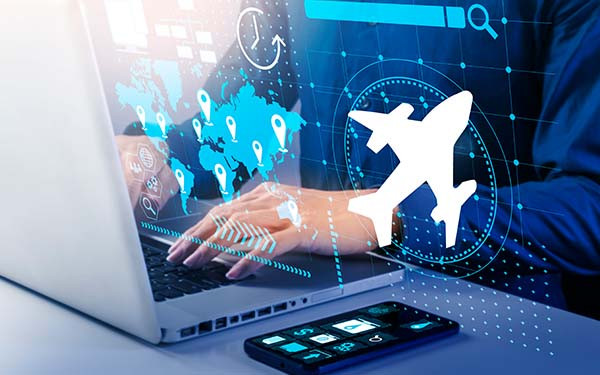 Person using a laptop with travel icons and a digital airplane overlay