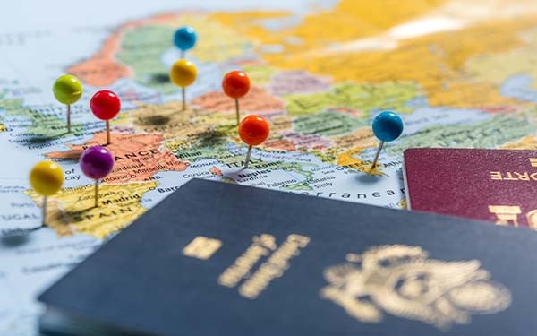 Map of Europe with pins in capital cities and two passports